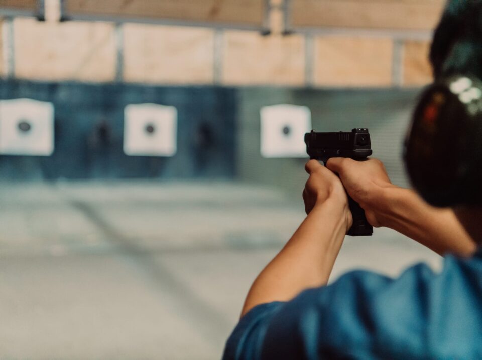 man-practices-shooting-pistol-shooting-range-while-wearing-protective-headphones-scaled (1)